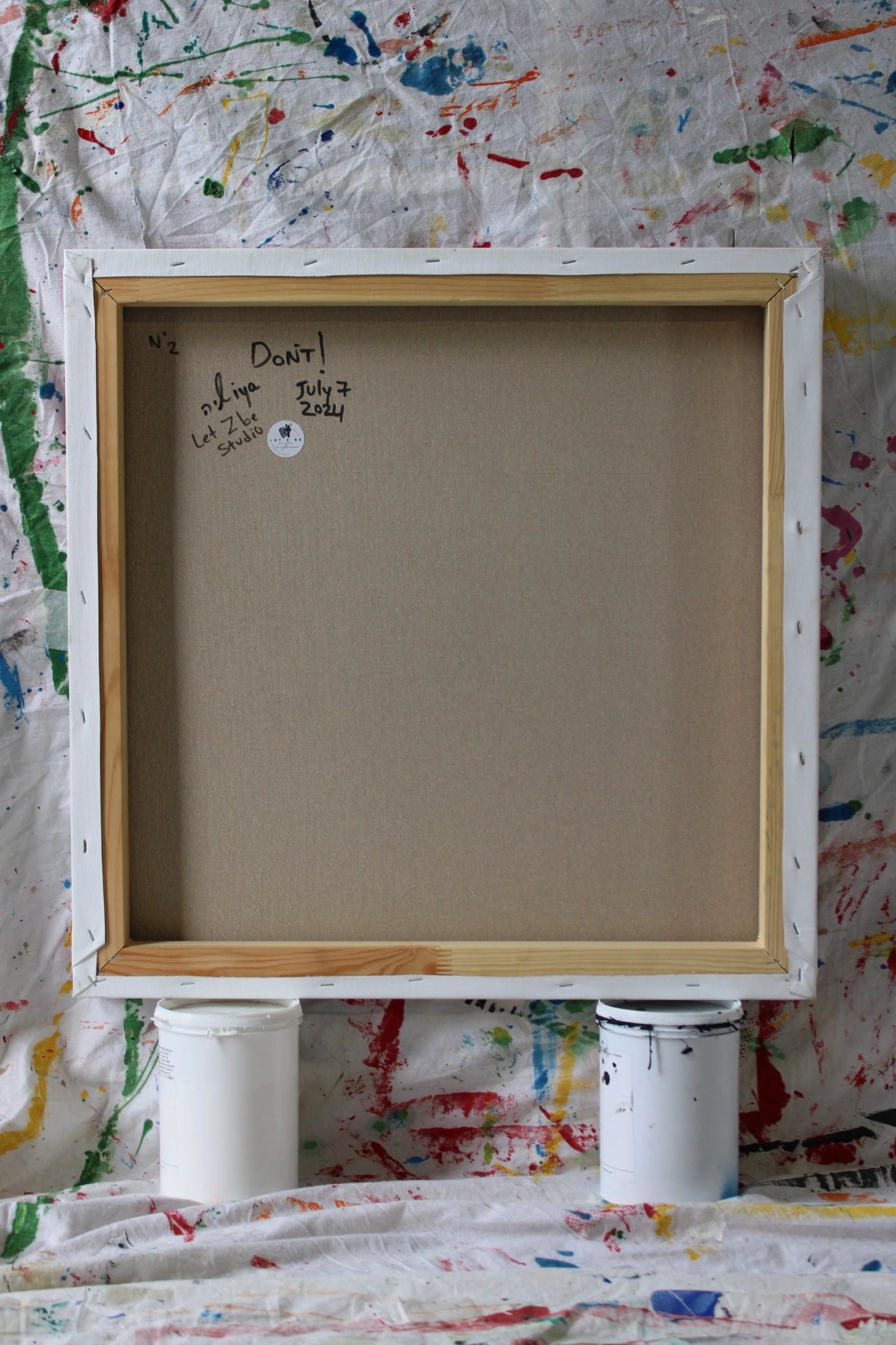 "Back view of the original painting 'DON'T' by Let Z Be Studio, featuring the artist's signature, creation date, and title of the artwork."