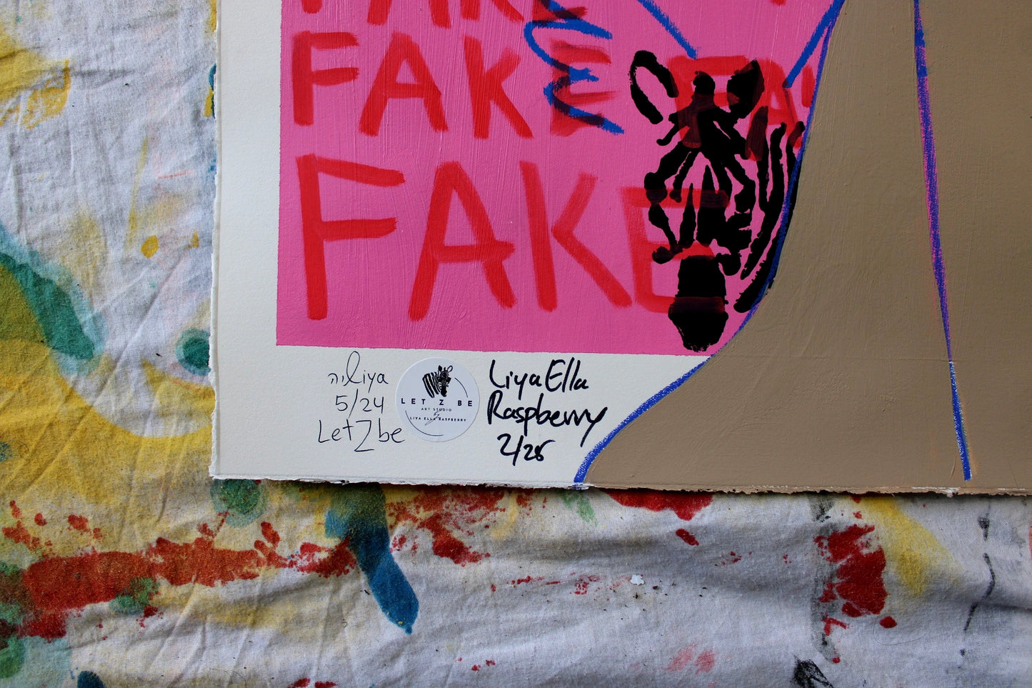 "Close-up of the signature and edition number on the bottom left corner of Liya Ella Raspberry’s painting from the expanded 'It Came Out a Bit Sad, So I Put on a Smile' series. The image shows the artist's signature, the 'Let Z Be' studio logo, and the unique edition number of the artwork."