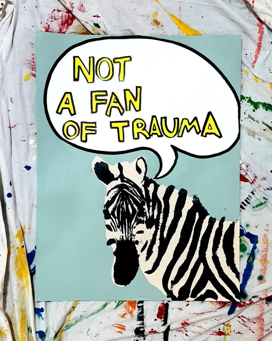 "Zebra pop art on blue background with comic-style bubble reading 'Not a Fan of Trauma!' in yellow and black text."
