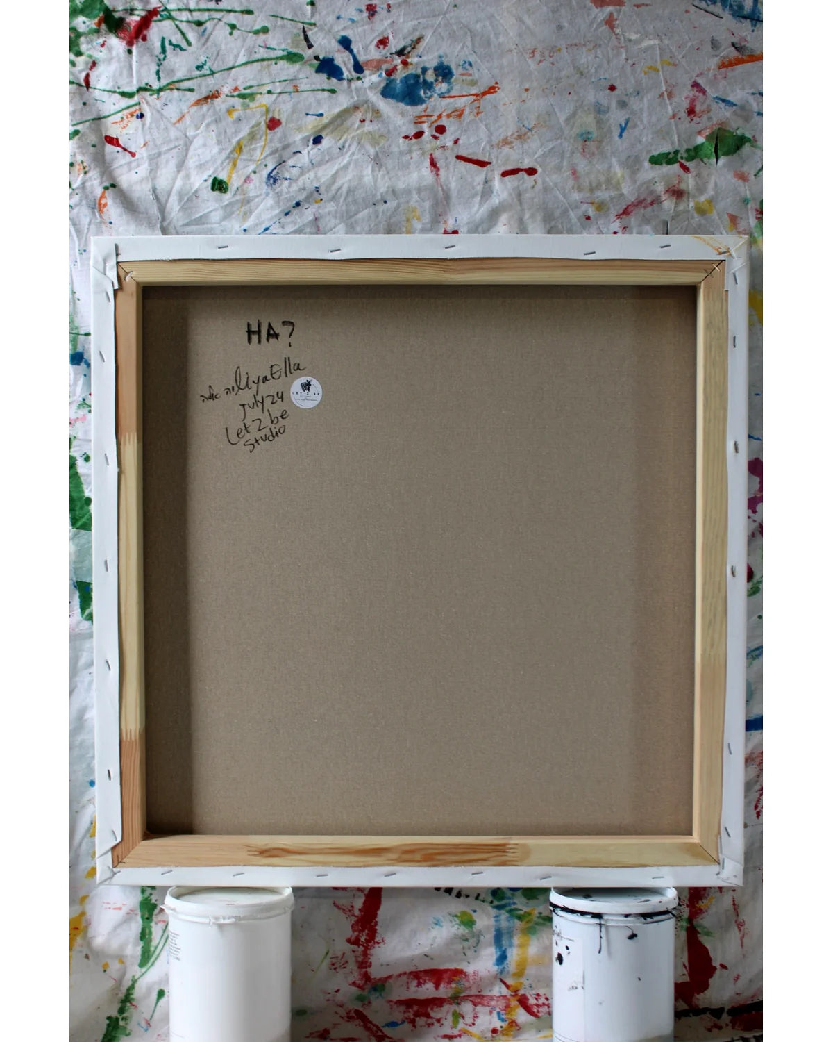 Back of the painting “HA?” showing artist’s signature and date on canvas — part of Let Z Be’s critical pop art collection.
