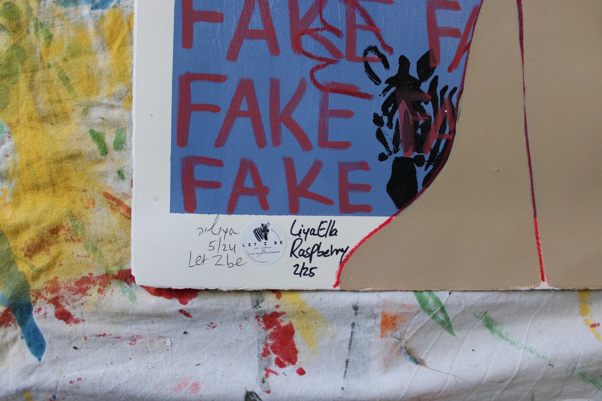 "Close-up of the signature and edition number on the bottom left corner of Liya Ella Raspberry’s painting from the expanded 'It Came Out a Bit Sad, So I Put on a Smile' series. The image shows the artist's signature, the 'Let Z Be' studio logo, and the unique edition number of the artwork."

