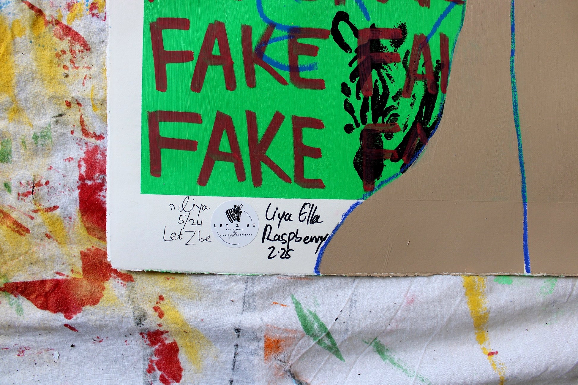 "Close-up of the signature and edition number on the bottom left corner of Liya Ella Raspberry’s painting from the expanded 'It Came Out a Bit Sad, So I Put on a Smile' series. The image shows the artist's signature, the 'Let Z Be' studio logo, and the unique edition number of the artwork."