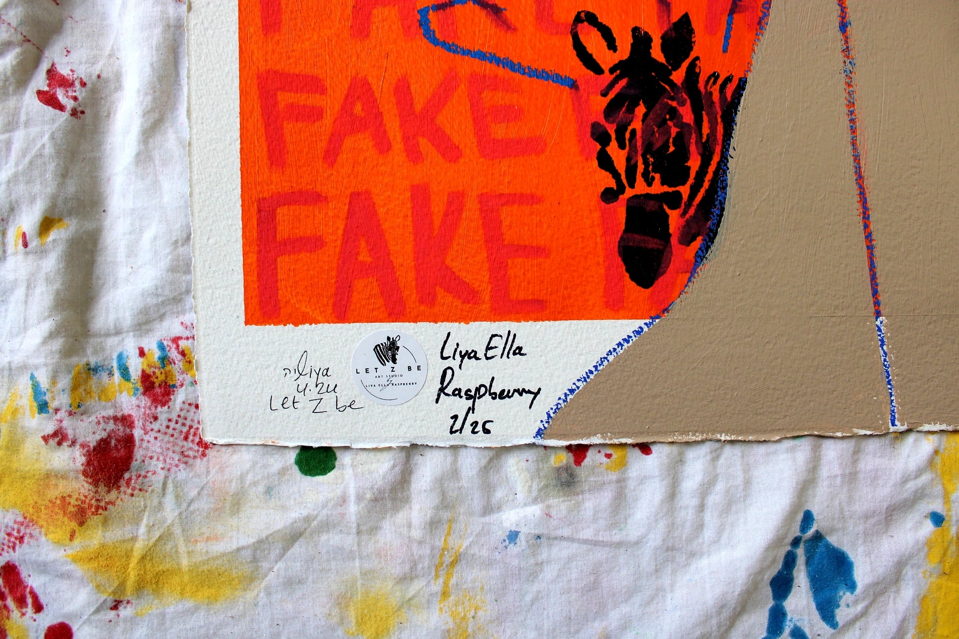 "Close-up of the signature and edition number on the bottom left corner of Liya Ella Raspberry’s painting from the expanded 'It Came Out a Bit Sad, So I Put on a Smile' series. The image shows the artist's signature, the 'Let Z Be' studio logo, and the unique edition number of the artwork."
