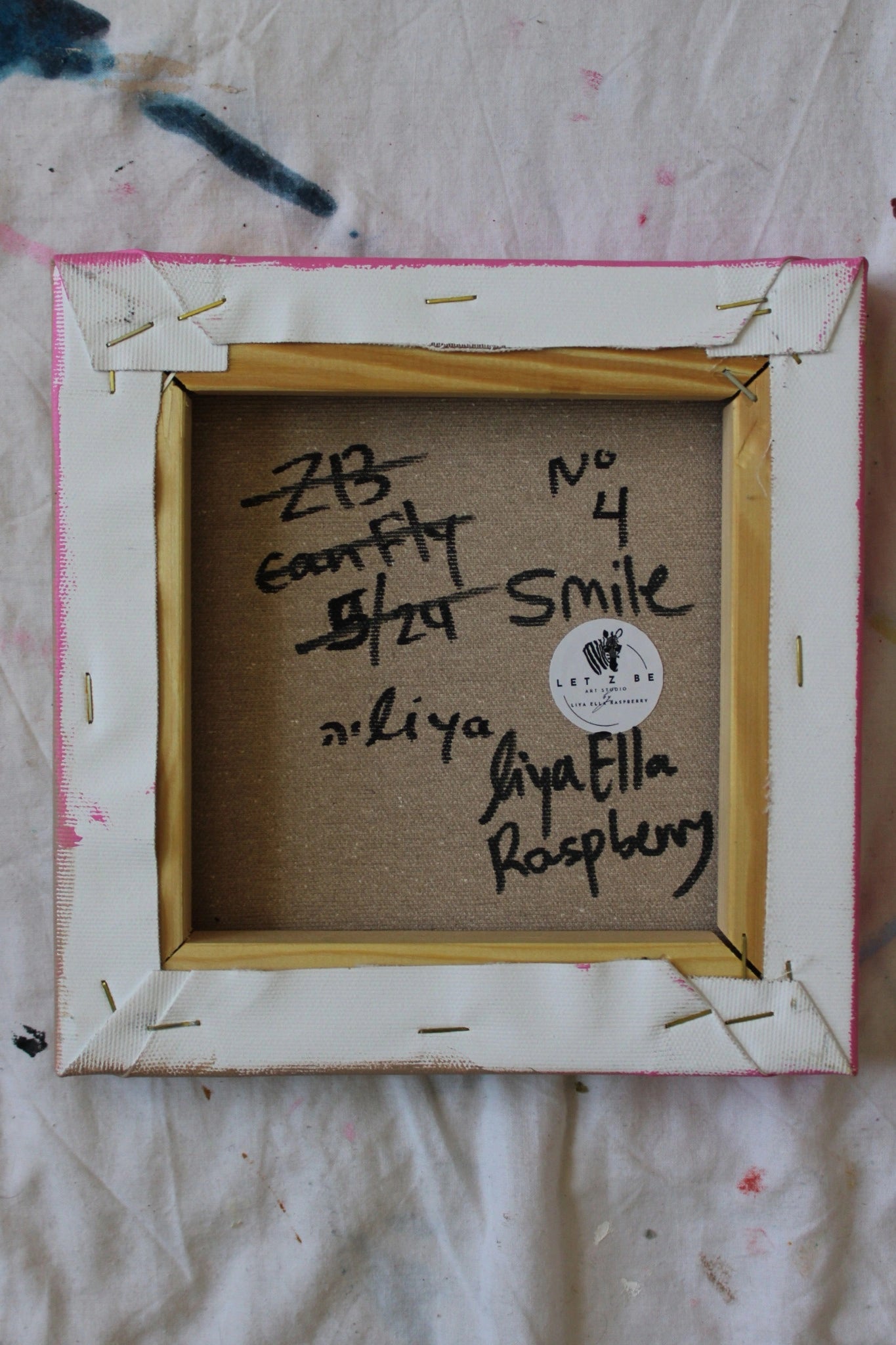 "Original artwork 'Smile No.4' by Liya Ella Raspberry — back view with signature, 2024 date, and Let Z Be studio logo on pop art canvas."
