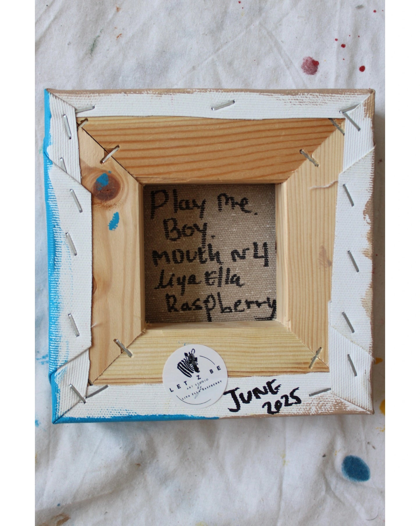 Backside of "Play Me, Boy. Mouth No.4" by Liya Ella Raspberry – signed canvas with Let Z Be studio sticker, dated June 2025, part of PLAY ME, BOY. series.